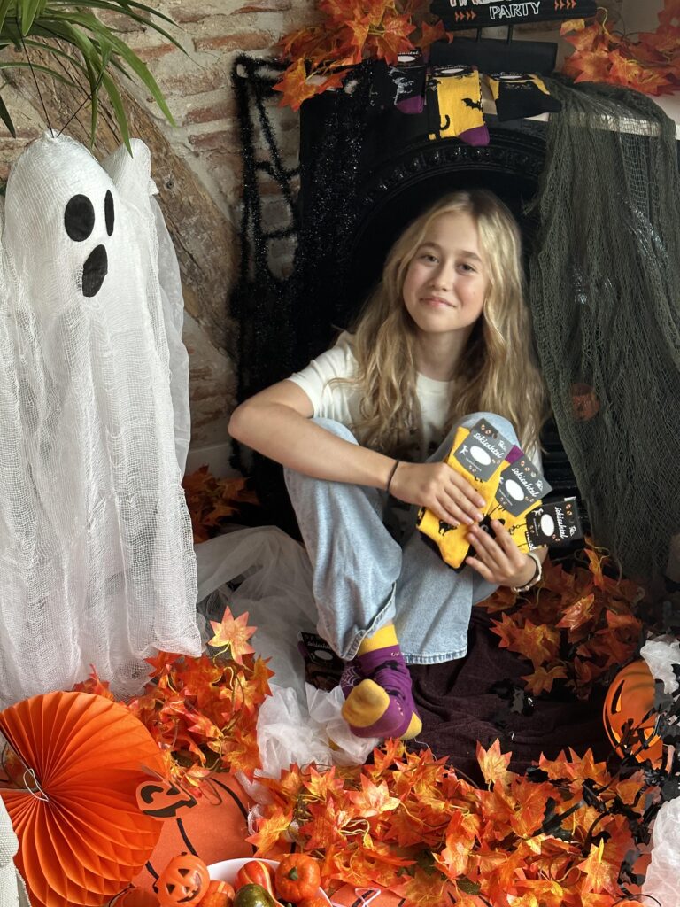 Halloween party decorations with spider webs, skeletons, and bats enhancing the festive display.