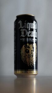 Close-up of a "Liquid Death" sparkling water can on a table