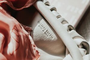 Close-up of a Bottega Veneta leather handbag interior with soft pink silk scarf detail