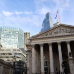 London's Bank of England and modern skyscrapers showing financial contrast.