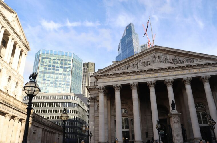 London's Bank of England and modern skyscrapers showing financial contrast.