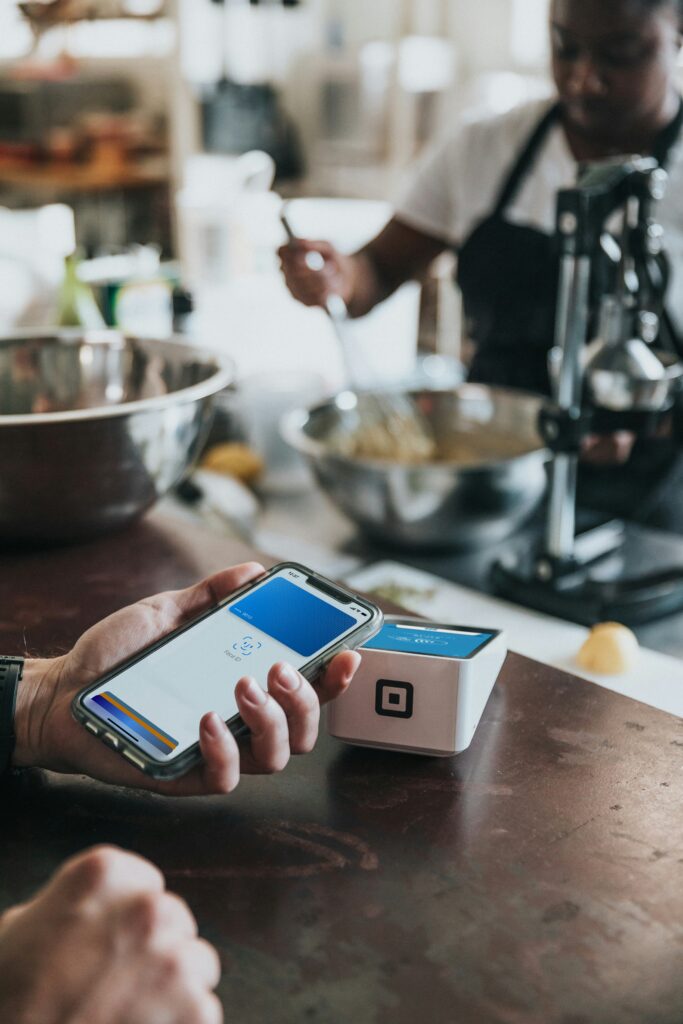 Contactless payment via smartphone being accepted by a Square reader in a shop.