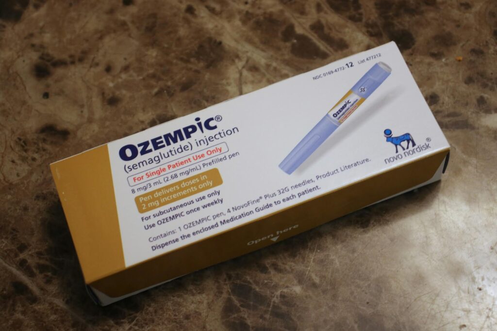 A box of Ozempic (semaglutide) injection 8mg/3mL sitting on a textured marble surface.