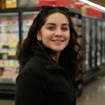 Woman shopping in a grocery store aisle - consumer psychology and shopping behavior