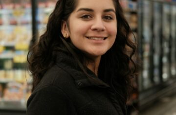 Woman shopping in a grocery store aisle - consumer psychology and shopping behavior
