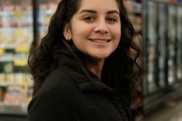 Woman shopping in a grocery store aisle - consumer psychology and shopping behavior