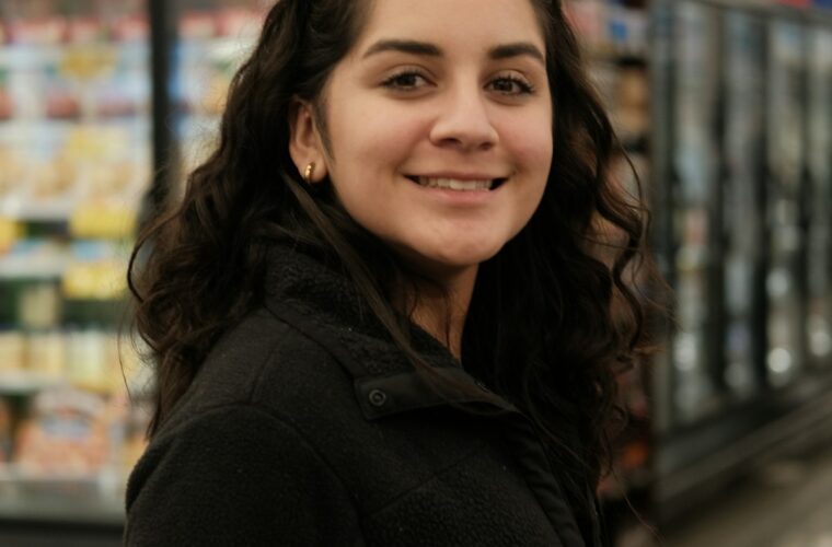 Woman shopping in a grocery store aisle - consumer psychology and shopping behavior